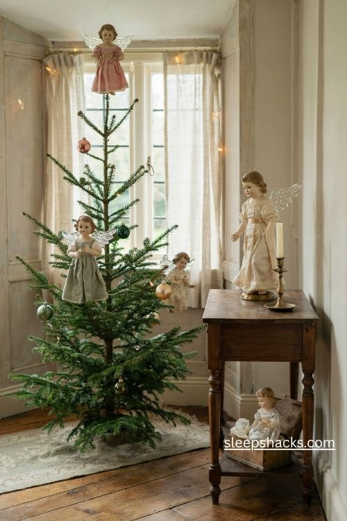 Antique wax faced christmas angels and paper cherubs with delicate spun glass wings on a vintage tree