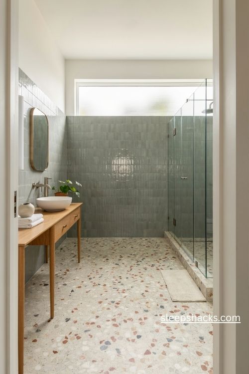 Bathroom flooring ideas with speckled terrazzo and sage green tiles 