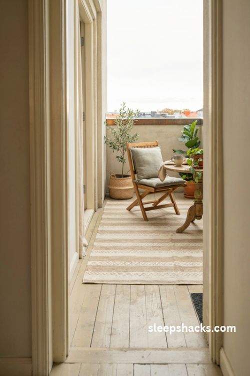Bedroom balcony ideas with a neutral weatherproof outdoor rug and cozy seating