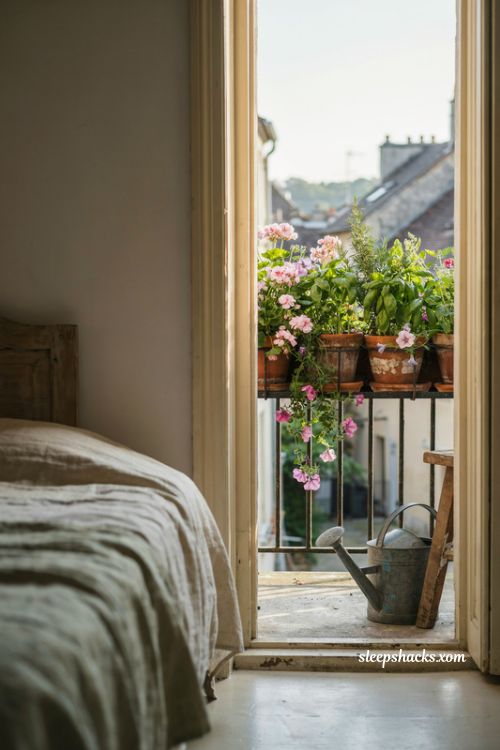 Bedroom balcony ideas with railing planters, fresh herbs and pink flowers