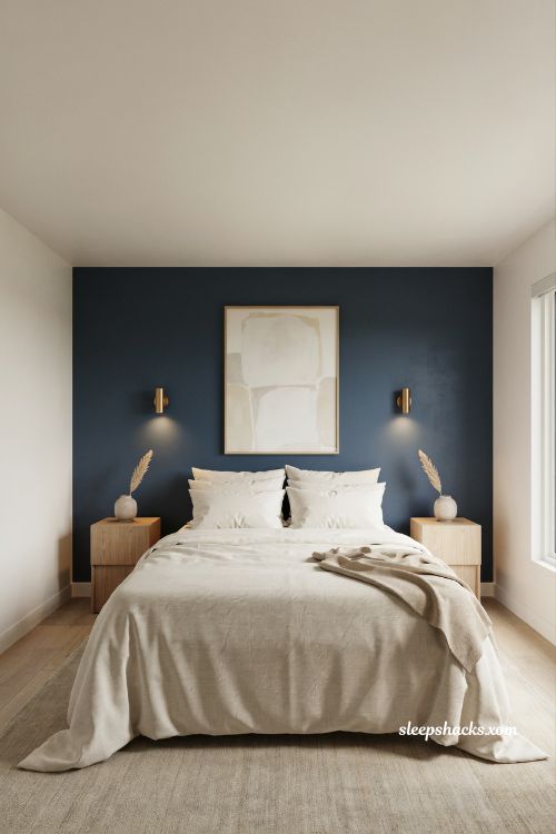 Bedroom wall ideas with a deep navy accent wall and cozy cream bedding 