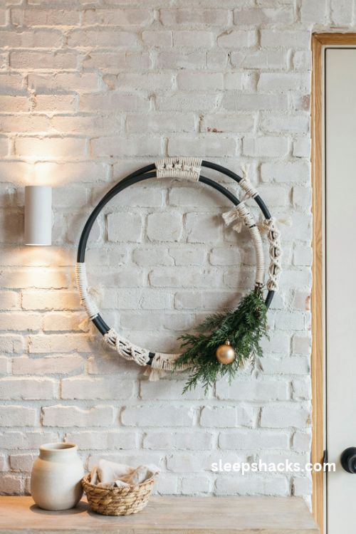 Black metal hoop macrame christmas wreath with white rope evergreen and gold ornament