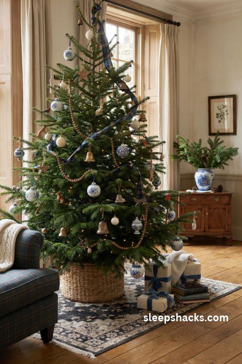 Blue and white Christmas tree with delft style ceramic ornaments wooden stars and brown plaid ribbon