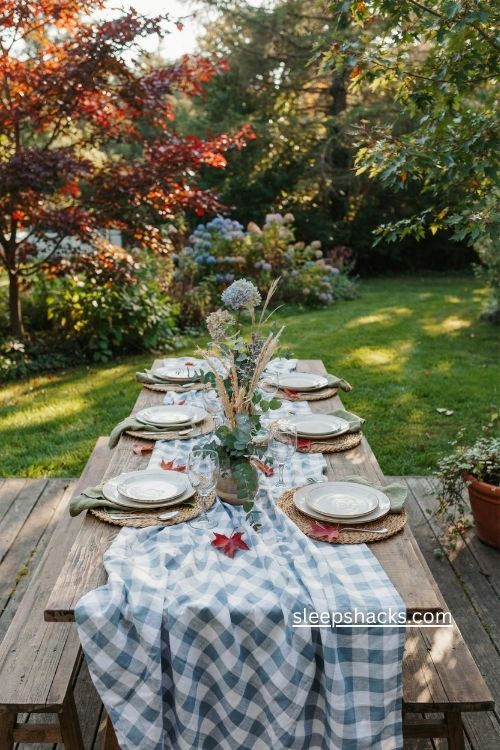 Blue and white checked thanksgiving table with green napkins and natural greenery