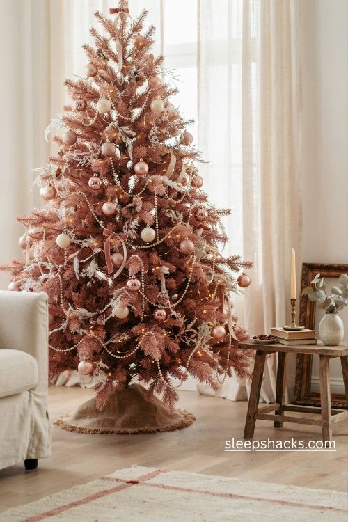 Blush pink and gold christmas tree decorated with elegant pearl strands and vintage beaded garlands