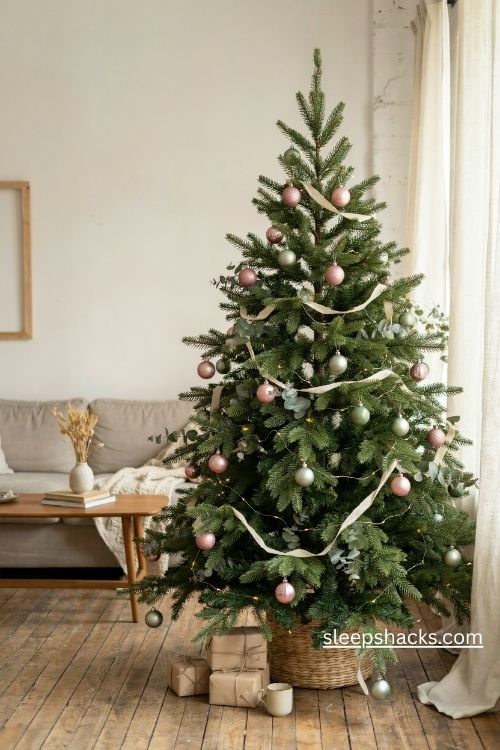 Blush pink and sage green Christmas tree with eucalyptus and cream linen ribbon