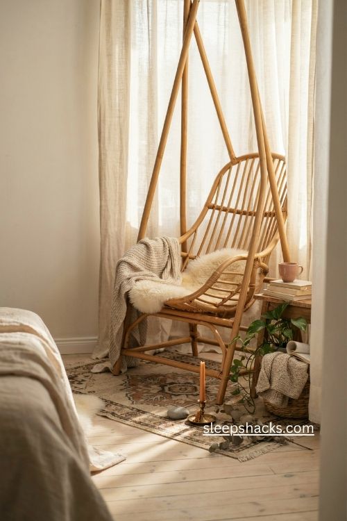 Boho bedroom swing chair reading nook with rattan chair sheepskin and woven textures 