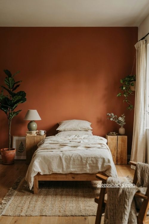 Burnt orange bedroom colour ideas with cream bedding natural wood and plants