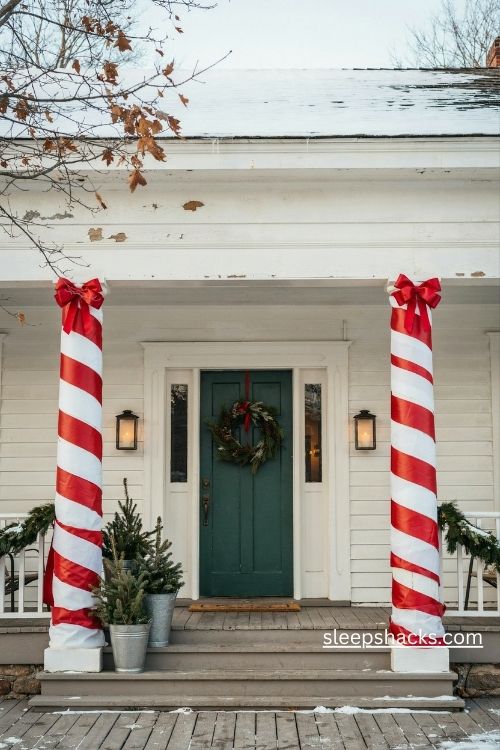 Candy cane wrapped porch columns with red and white ribbon for playful christmas decor