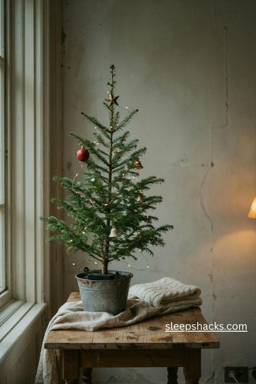 Charlie brown christmas tree with delicate warm white fairy lights on sparse branches in a cozy farmhouse interior