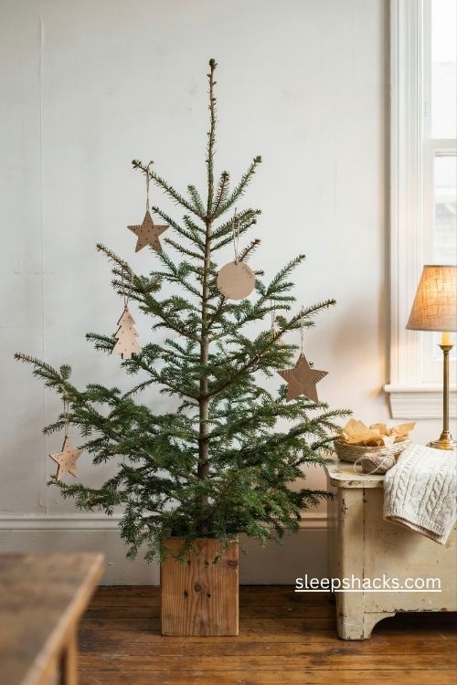 Charlie brown christmas tree with handmade kraft paper and cardboard ornaments in a rustic farmhouse interior