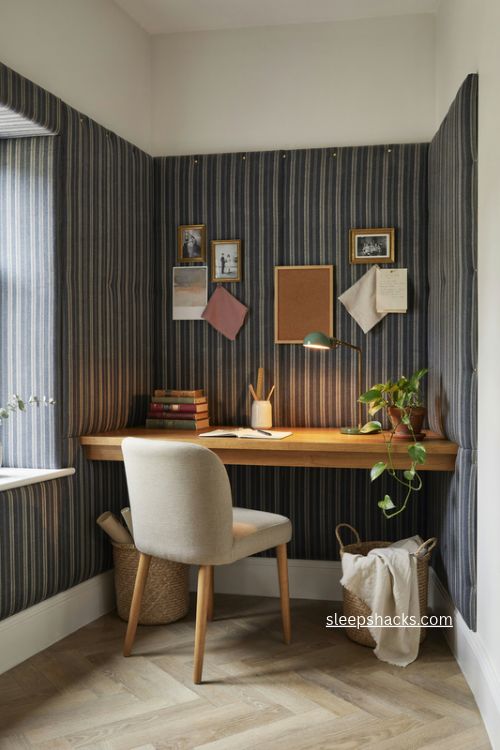 Chic home office with a navy striped fabric bulletin board wall and cozy desk alcove 