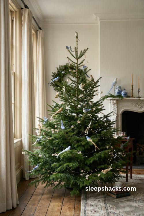 Chinoiserie Christmas tree with blue white and gold bird ornaments and delicate floral decorations
