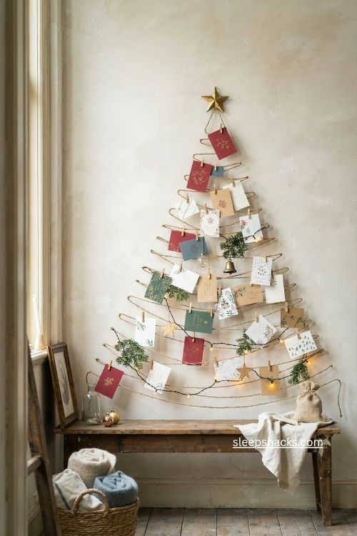 Christmas card tree with vintage holiday cards twine clothespins and ornaments on a cozy cottage entryway wall 