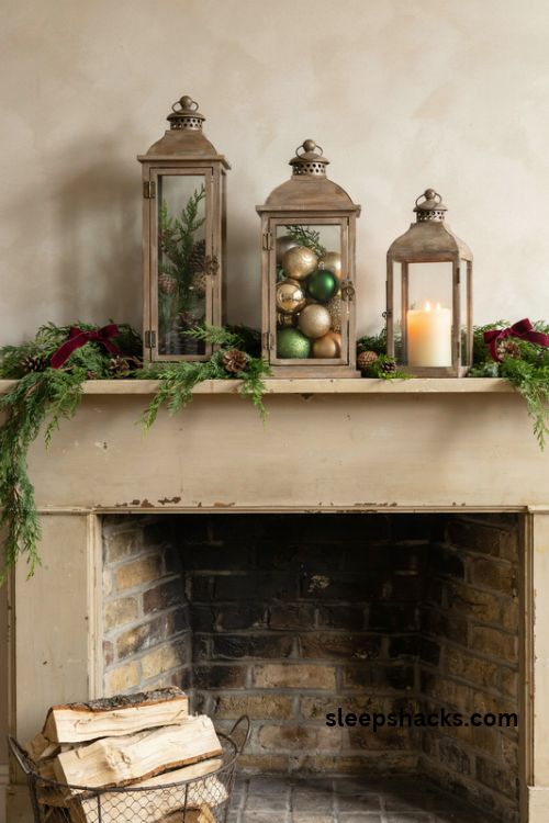 Christmas mantel lantern trio with evergreen garland vintage ornaments and warm candlelight