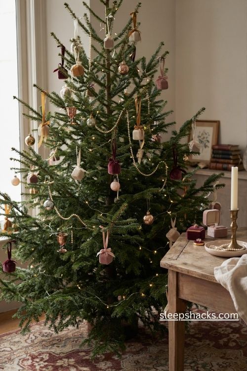 Christmas tree decorated with miniature jewelry gift boxes velvet ring cases and vintage ribbon bows
