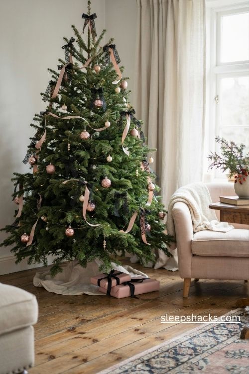 Christmas tree with black lace bows pink satin ribbons and delicate pearl ornaments