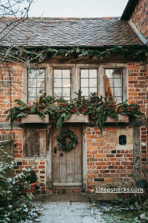 Christmas window boxes filled with fresh evergreen branches pinecones and red berries