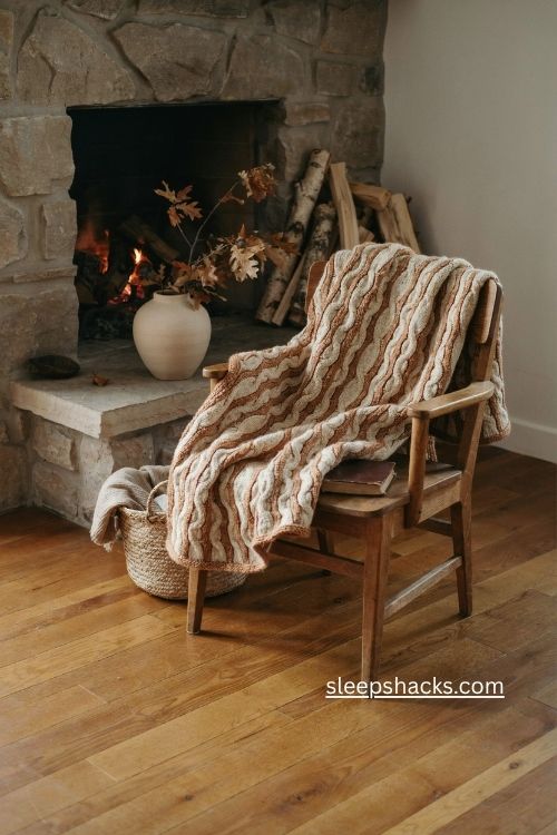 Chunky caramel and cream knit blanket on wooden chair cozy fall fireplace