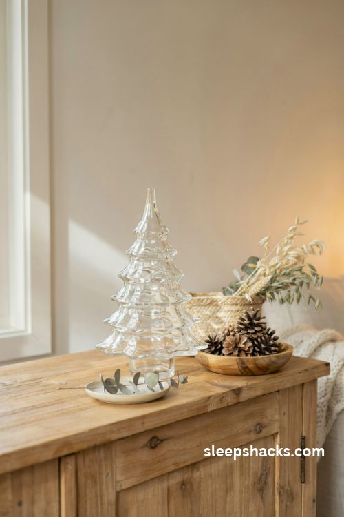 Clear glass christmas tree with pinecones woven baskets and neutral winter decor