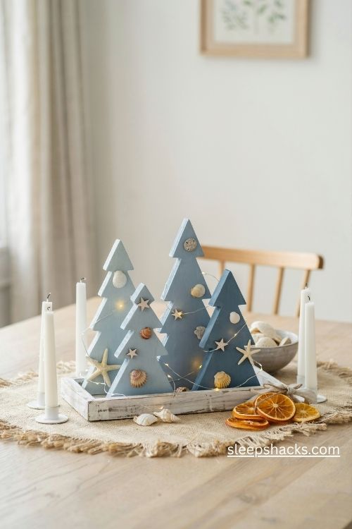 Coastal blue wooden christmas trees with seashells on a driftwood centerpiece tray 