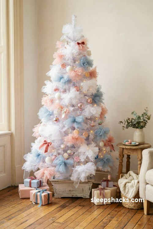 Cotton candy tulle christmas tree with fluffy pink blue and white fabric puffs and pastel candy ornaments