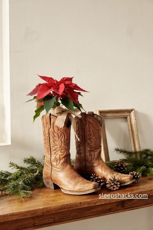 Cowboy boots with red poinsettias and burlap ribbon for rustic western farmhouse Christmas decor
