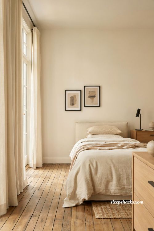 Cozy cream bedroom design with subtle black metal accents and warm wood tones