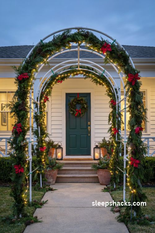 DIY PVC pipe Christmas arch with evergreen garland and porch lights