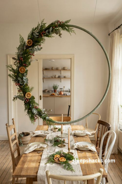 DIY half hoop Christmas arch with dried oranges and evergreen garland