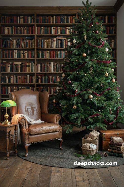 Dark academia christmas tree with charcoal tweed tree skirt vintage leather trunk and antique holiday decor