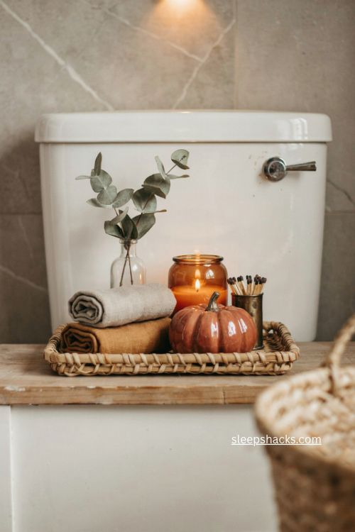 Fall toilet tank decor with rattan tray greenery candle and guest towels