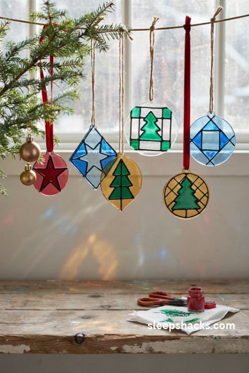 Faux leading stained glass Christmas ornaments with glossy jewel toned colors and red ribbon