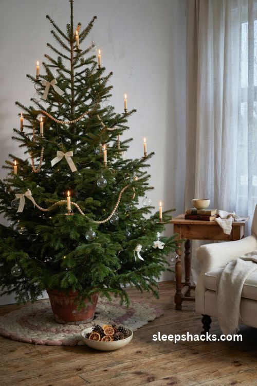 French country Christmas tree with flameless candle ornaments antique brass holders wooden bead garland and warm fairy lights