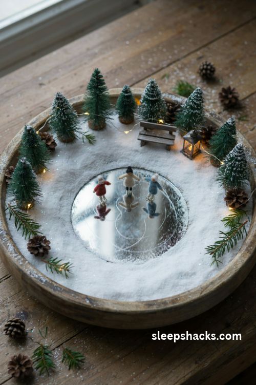 Frozen pond skating Christmas diorama with tiny ice skaters, reflective mirror ice, snowy evergreens, and a rustic miniature bench 