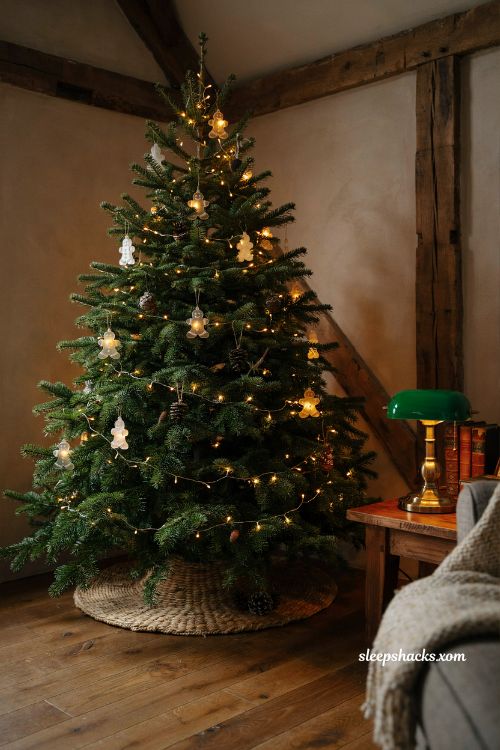 Gingerbread christmas tree illuminated with warm amber white lights in a cozy living room