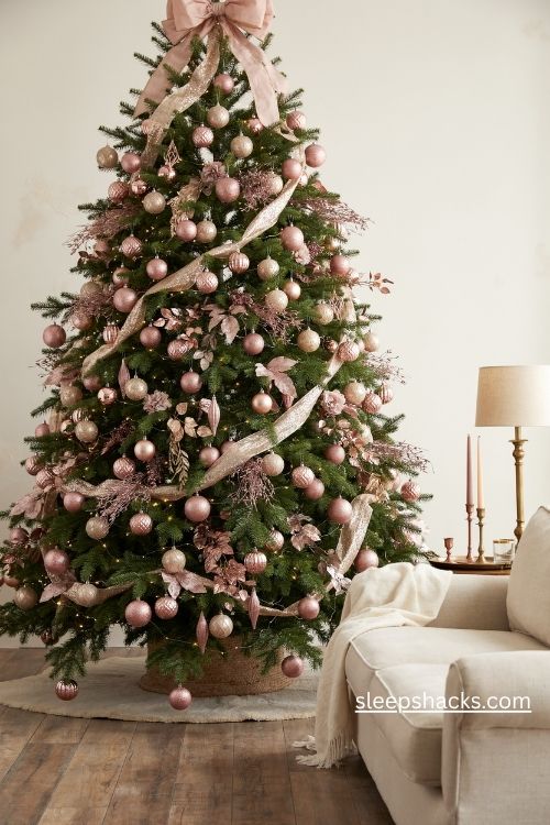 Glitter and shimmer maximalist christmas tree with blush pink champagne ornaments and oversized bow