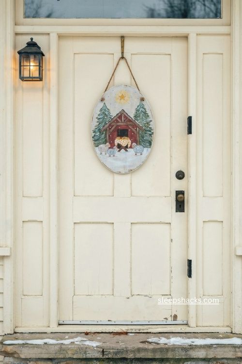 Hand painted nativity Christmas door hanger with sheep and red stable