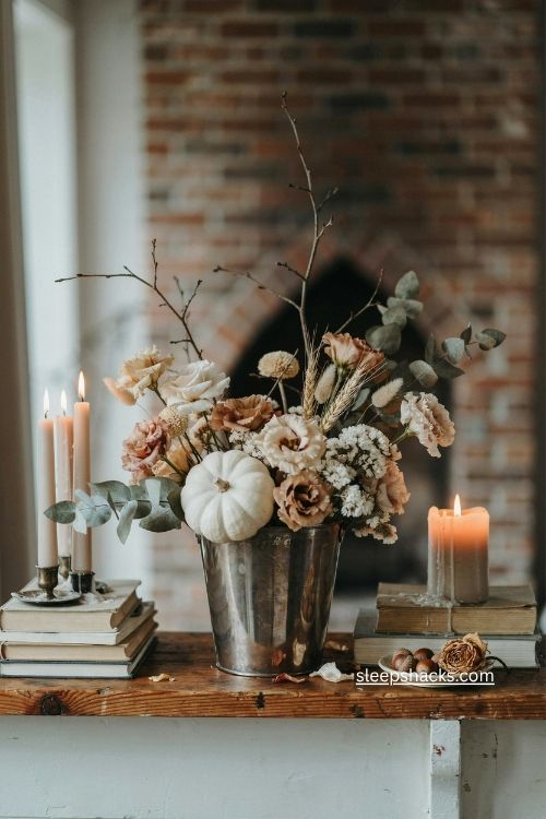 Harvest bouquet in a tarnished silver wine bucket with white pumpkin 
