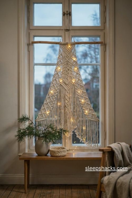 Illuminated macrame Christmas tree window hanging with warm white fairy lights and natural cotton fringe