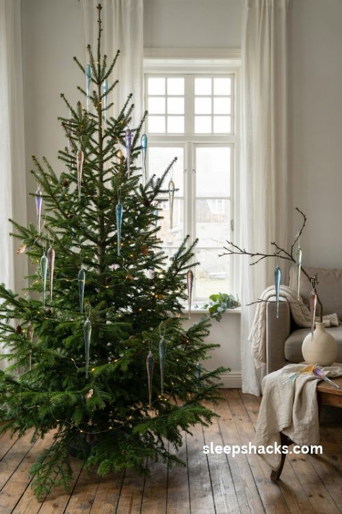 Iridescent glass icicle christmas ornaments cascading on a cozy evergreen tree