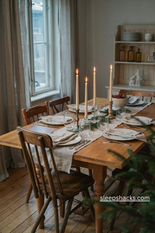Ivory taper candles in mixed brass glass and wooden holders for christmas dinner
