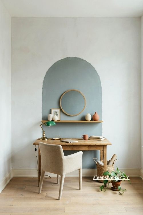 Layered sage paint arch behind a cozy small home office desk
