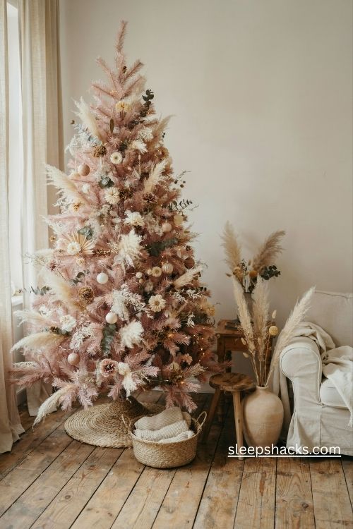 Light pink christmas tree with pampas grass dried bunny tails and muted boho floral decorations