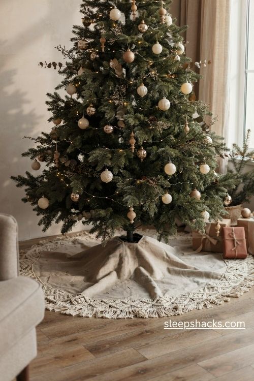 Macrame Christmas tree skirt with natural cotton fringe and diamond knots beneath a real evergreen tree