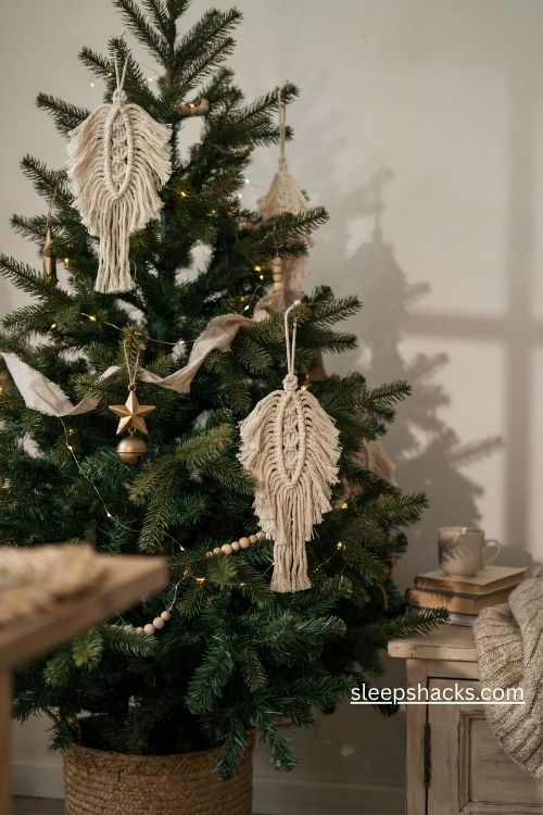 Macrame feather Christmas ornaments diy in natural cotton cord on a cozy rustic pine tree
