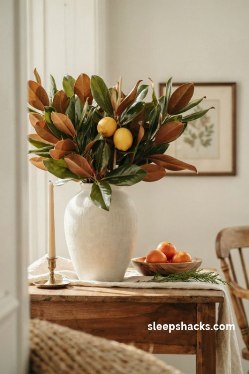 Magnolia leaves and fresh citrus fruit in an elegant Christmas vase arrangement