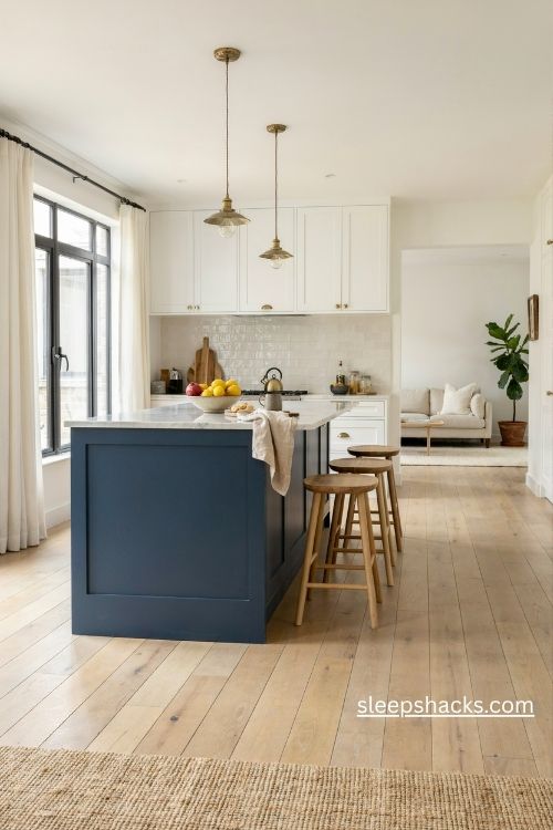 Midnight blue kitchen island with white quartz countertops and warm wooden stools
