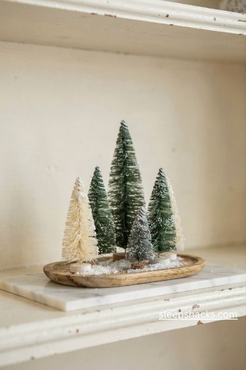 Mini christmas trees in white green and silver on a vintage christmas hutch