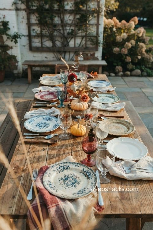 Mismatched vintage china thanksgiving table with heirloom plates and stemware 